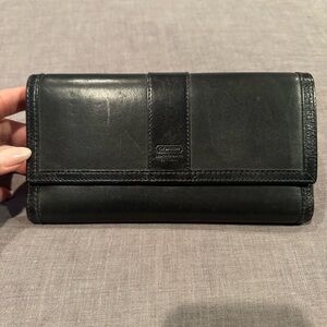 Coach black leather wallet with check book holder.
